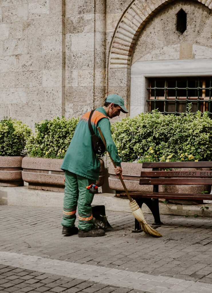 a man sweeping the pavement